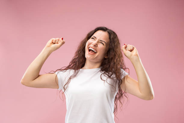 istock Winning success woman happy ecstatic celebrating being a winner. Dynamic energetic image of female model 1044319828