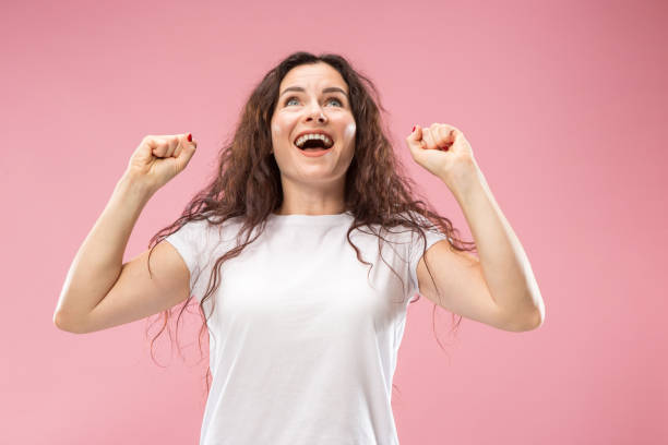 istock Winning success woman happy ecstatic celebrating being a winner. Dynamic energetic image of female model 1044319840