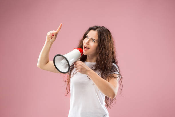 istock Woman making announcement with megaphone 1044319866