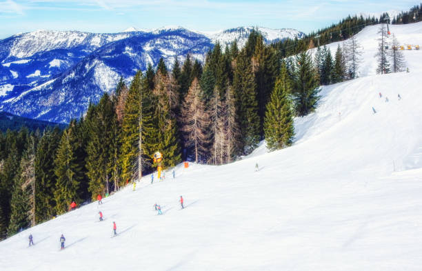 istock People skiing and snowboarding on a slope at ski resort 1044319984