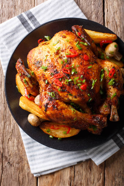 istock grilled chicken with fried mushrooms and potatoes close-up. vertical top view 1044323770