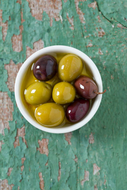 istock olives in a bowl on wooden surface 1044323808