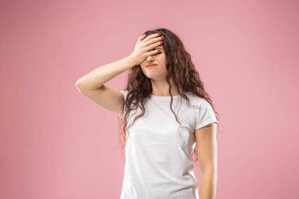istock Beautiful woman looking bewildered isolated on pink 1044326362