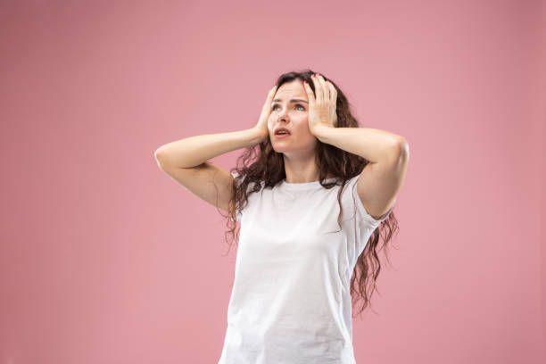 istock Beautiful woman looking bewildered isolated on pink 1044326364
