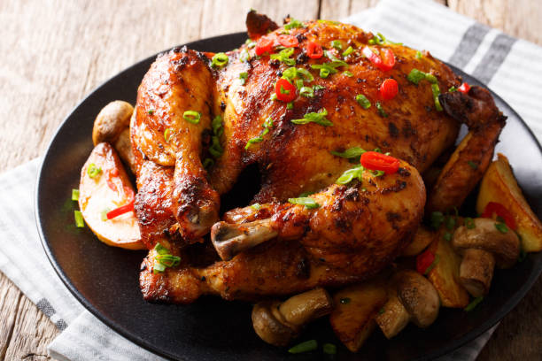 istock Festive food: fried chicken with mushrooms and potatoes close-up on a plate. horizontal 1044326366