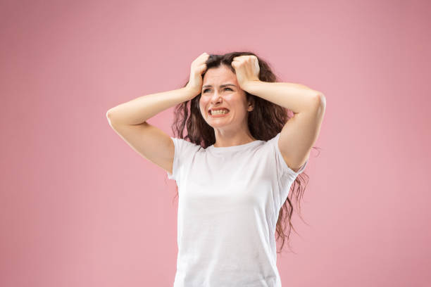 istock Beautiful woman looking bewildered isolated on pink 1044326374