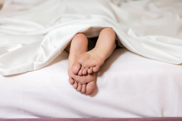 istock Crop female feet on white beg 1044331798