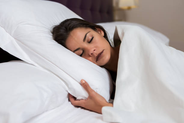 istock Sleeping charming woman on white bed 1044331834