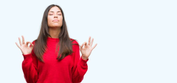 istock Young beautiful hispanic wearing red sweater relax and smiling with eyes closed doing meditation gesture with fingers. Yoga concept. 1044335014