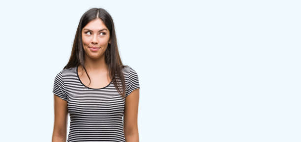 istock Young beautiful hispanic woman smiling looking side and staring away thinking. 1044335252
