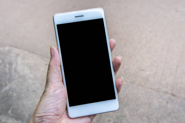 istock hand holding mobile phone and copy space background 1044336120