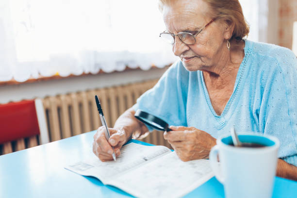Senior woman enjoys solving a crossword puzzle