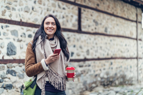 istock Young woman texting on her phone 1044339554
