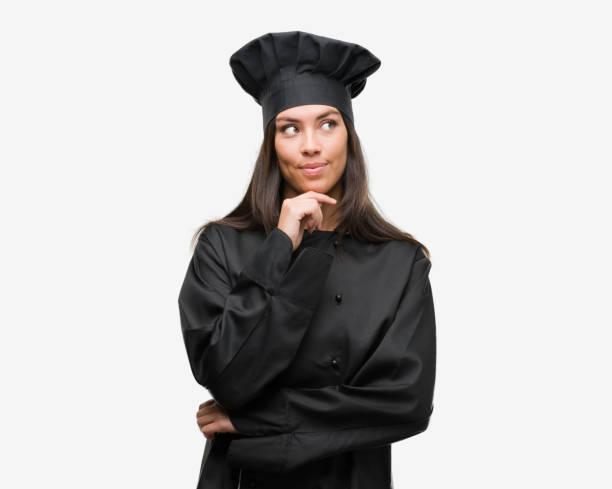 istock Young hispanic cook woman wearing chef uniform serious face thinking about question, very confused idea 1044344064