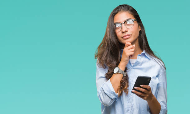 istock Young beautiful arab woman texting using smartphone over isolated background serious face thinking about question, very confused idea 1044344510