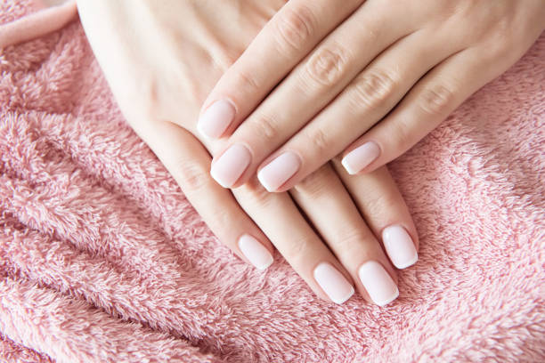 istock Manicured hands on towel. French manicure. 1044346578