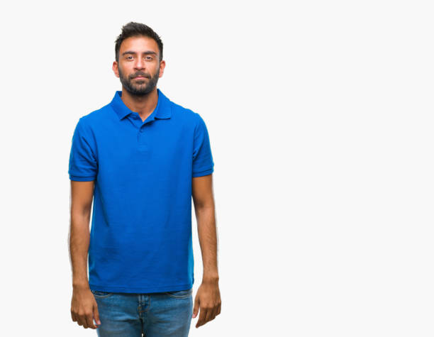 istock Adult hispanic man over isolated background with serious expression on face. Simple and natural looking at the camera. 1044347148