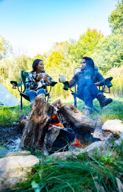 istock A cute millennial couple relaxing by a campfire at a campsite. 1044347604