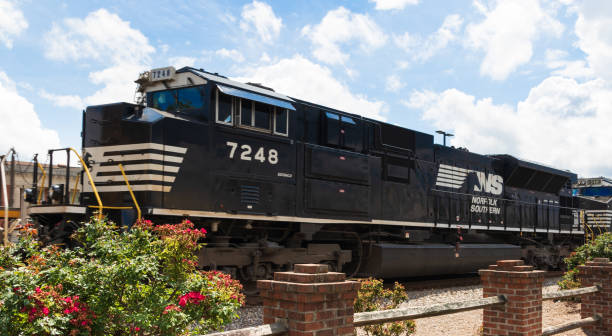 Locomotive passing train station Hickory, NC, USA-26 May 18: A Norfolk Southern locomotive pulls its cargo through a downtown area. south stock pictures, royalty-free photos & images
