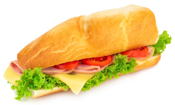 istock Fresh baguette sandwich with ham, cheese, tomatoes, and lettuce isolated on white background 1044351424