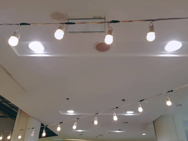 istock Low Angle View of Rows of Illuminated Lamps Against Ceiling 1044353494
