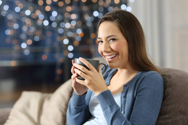 istock Lady looking at camera holding a coffee mug 1044354390