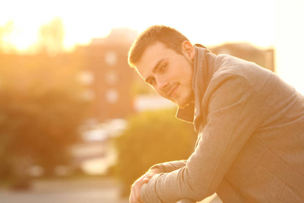 istock Man looking at camera in a balcony in winter 1044354600