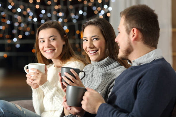 istock Three friends having a conversation in the night at home 1044355000