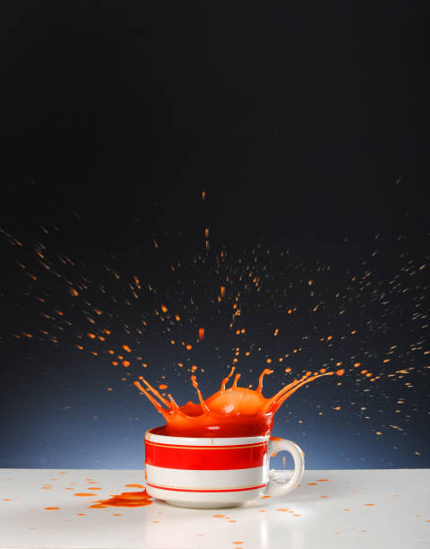 Tomato soup splashing on black background