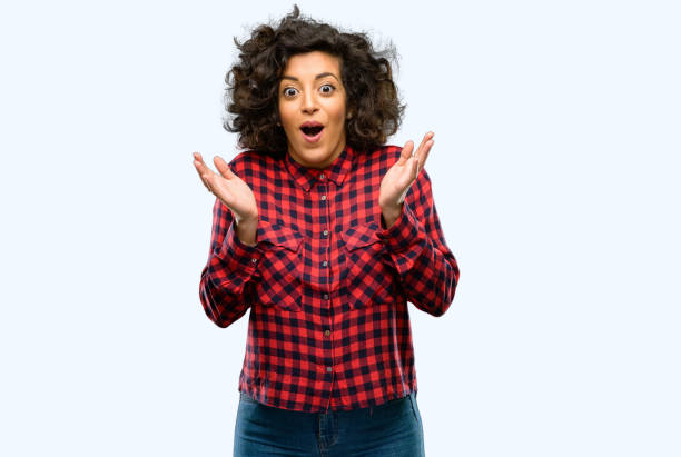 istock Beautiful arab woman happy and surprised cheering expressing wow gesture 1044357948