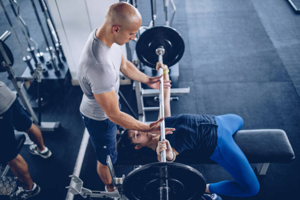 istock Trainer with woman in gym 1044361074