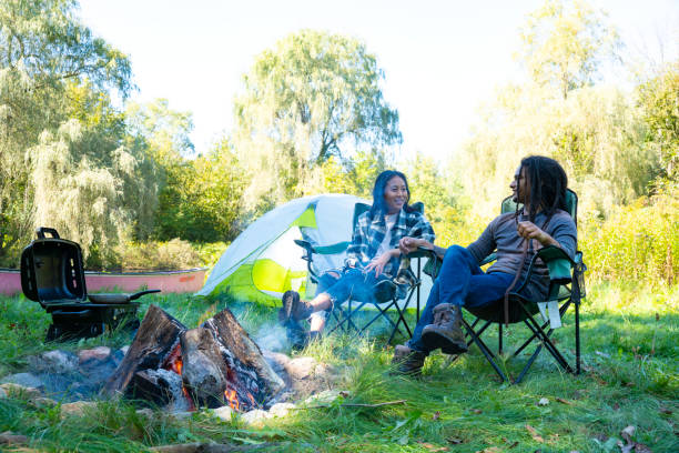 istock A cute millennial couple relaxing by a campfire at a campsite. 1044362070