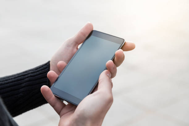 istock Man uses his mobile phone outdoor. 1044364396