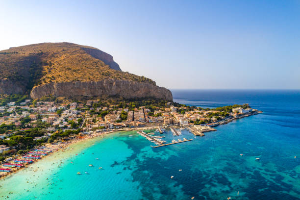 Sicily Island in Palermo, Italy, Europe Palermo, Sicily, Italy - August 8, 2017:   view showing Sicily island, boats in the sea, trees, buildings and mountains can be seen on the background sicily stock pictures, royalty-free photos & images