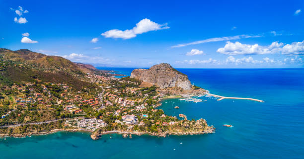 Sicily Island in Cefalu, Italy, Europe Cefalu, Sicily, Italy - August 10, 2017: Sicily view showing Cefalu old town, rock mountains, trees, houses, boats sorrounded by the sea cefalu stock pictures, royalty-free photos & images