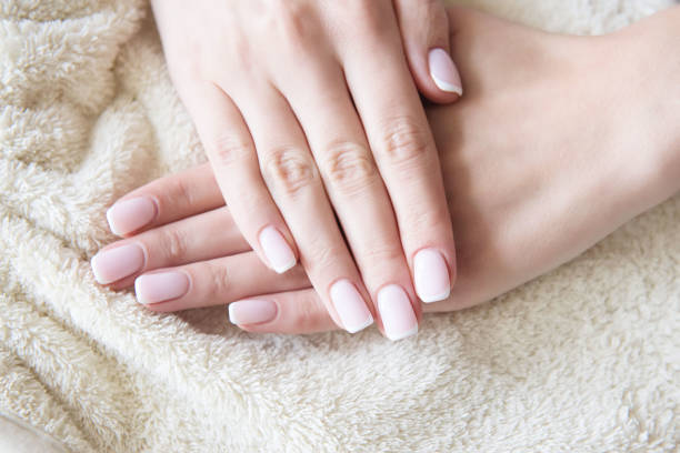 istock Manicured hands on towel. French manicure. 1044367696