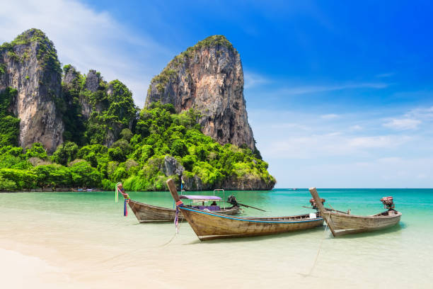 Thai traditional wooden longtail boat Thai traditional wooden longtail boat and beautiful sand Railay Beach in Krabi province. Ao Nang, Thailand. phi phi islands stock pictures, royalty-free photos & images