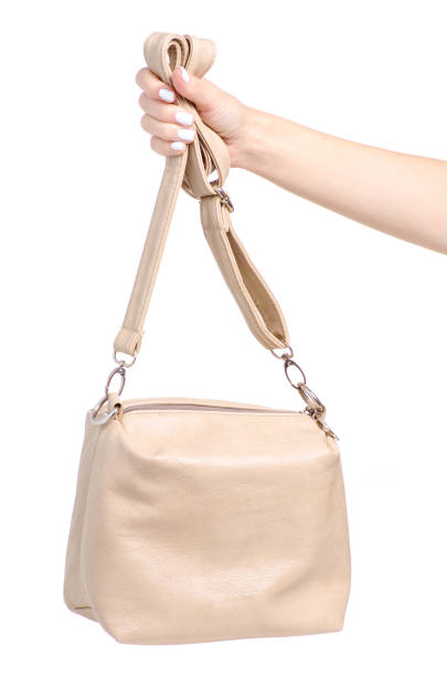istock Female beige leather bag in hand 1044376842