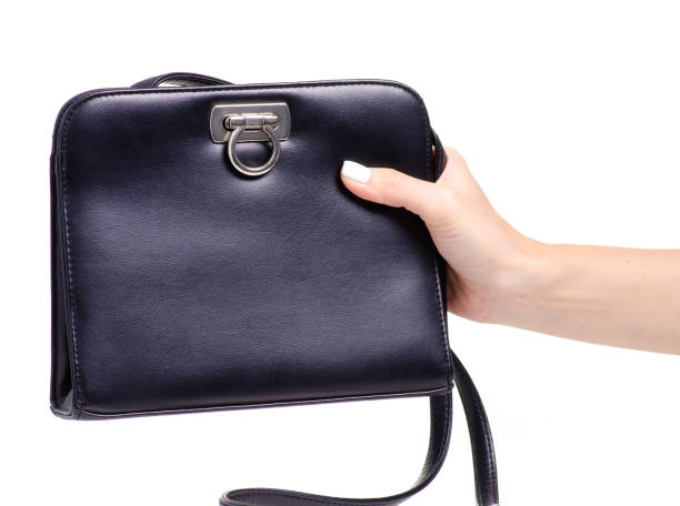 istock Female black leather bag in hand 1044377024