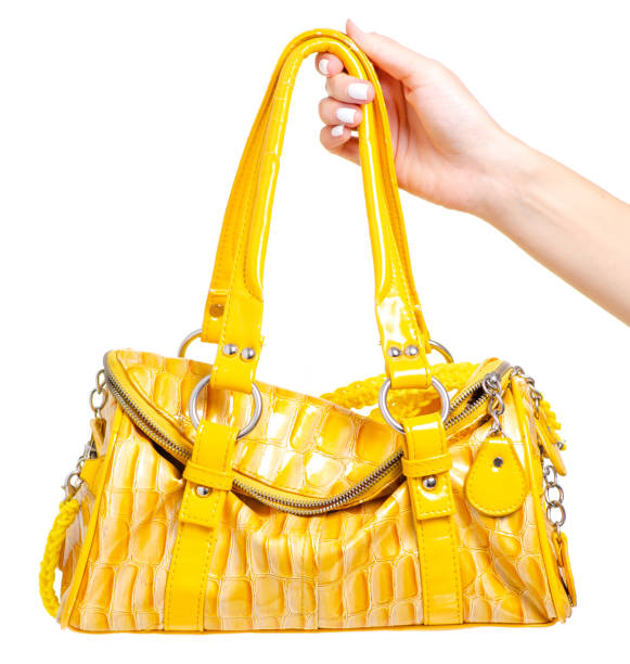 istock Female yellow leather bag in hand 1044377442
