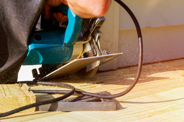 istock Carpenter building cutting electric circular saw wooden deck 1044381050