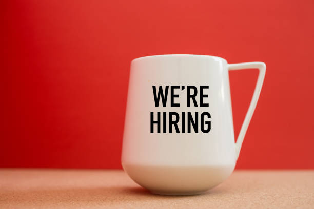 istock We're Hiring on white cup against red background - Business Concept 1044387556