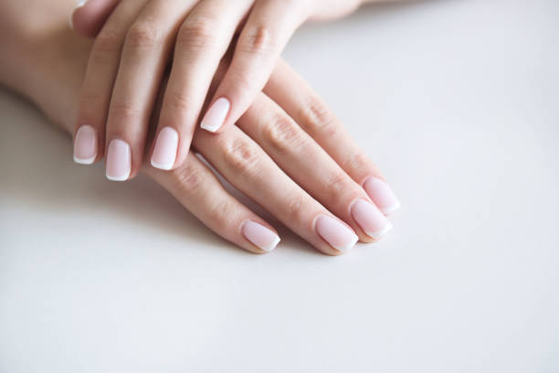 istock Manicured hands on towel. French manicure. 1044387806