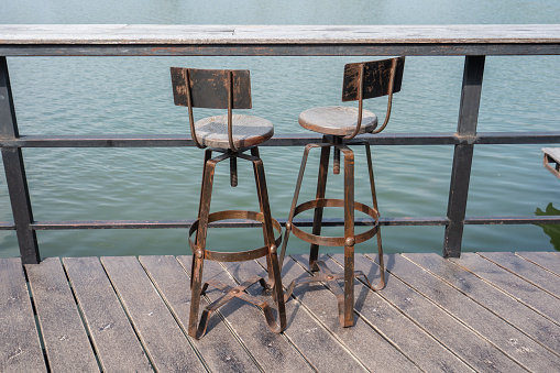 Two vintage style chairs are paired together.