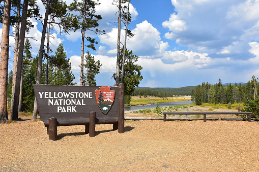 Yellowstone National Park, Wyoming, USA - September 6, 2018 Sign at the South Entrance - welcomes visitors to the park with the Snake River in the background