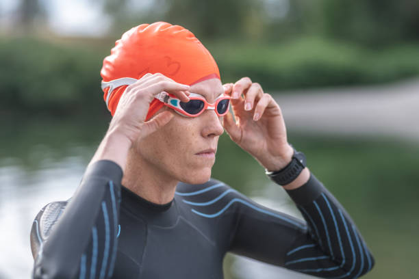 istock A middle-aged female triathlete changes into her wetsuit 1044395590