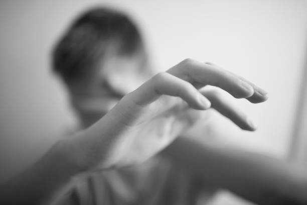 Boy teenager protects himself with his hands