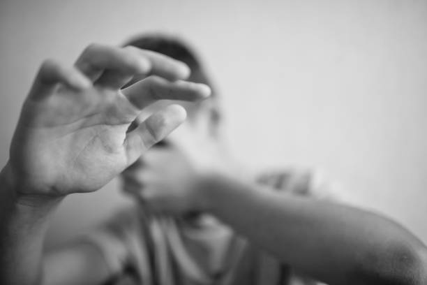 istock Boy teenager protects himself with his hands 1044396336