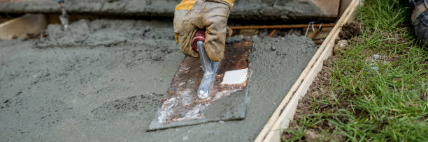 istock Closeup of gloved hand smoothing concrete surface 1044398770