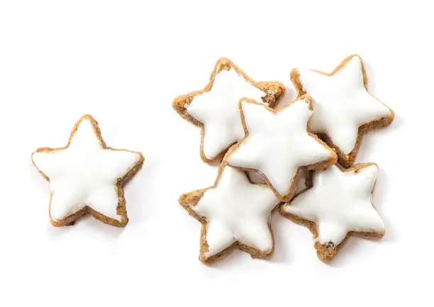 Typical Christmas cinnamon star cookies on white background